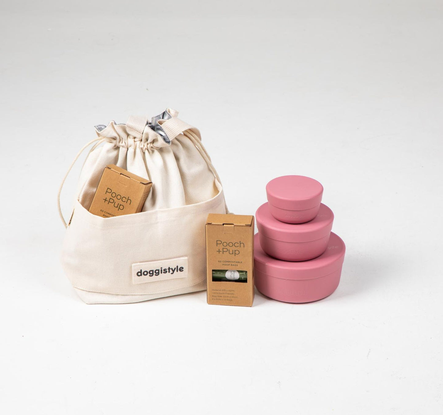 Dog food cooler travel bag & dog food storage containers in pink plus compostable poop bags.